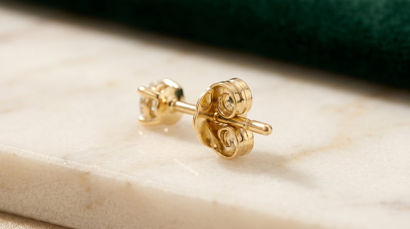 Detail of a screw-stud post closure with a visible 14-karat gold butterfly backing